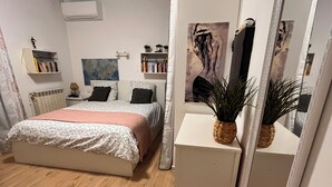 A bedroom with a bed, bedside tables, a radiator, a bookshelf, and a mirror. - Villa with private pool - garden - family vacations near the sea (La Garde)