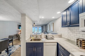 Enjoy ocean views from this kitchen, which features a dishwasher and stainless steel sink.