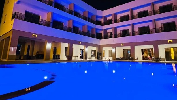 A multi-story hotel with a swimming pool in the foreground. - Z Hotel Meknes (Majjate)