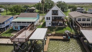 A waterfront property with a main house, a dock, and several smaller buildings.