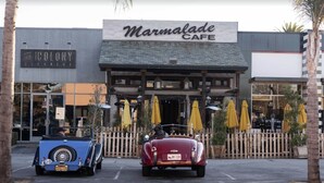A building with a sign that reads "Marmalade Cafe" and two vintage cars parked in front. - OCEAN VIEW BUNGALOW - MALIBU, CA (Malibu)