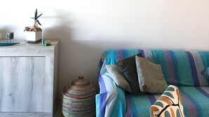 Une pièce comprenant un lit, une table de chevet et un tableau accroché au mur.