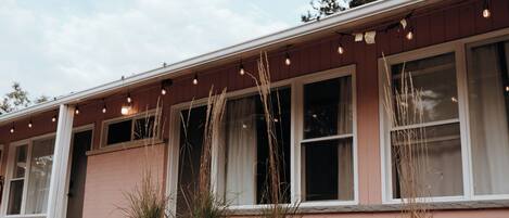 A building with a wooden deck and a row of windows.