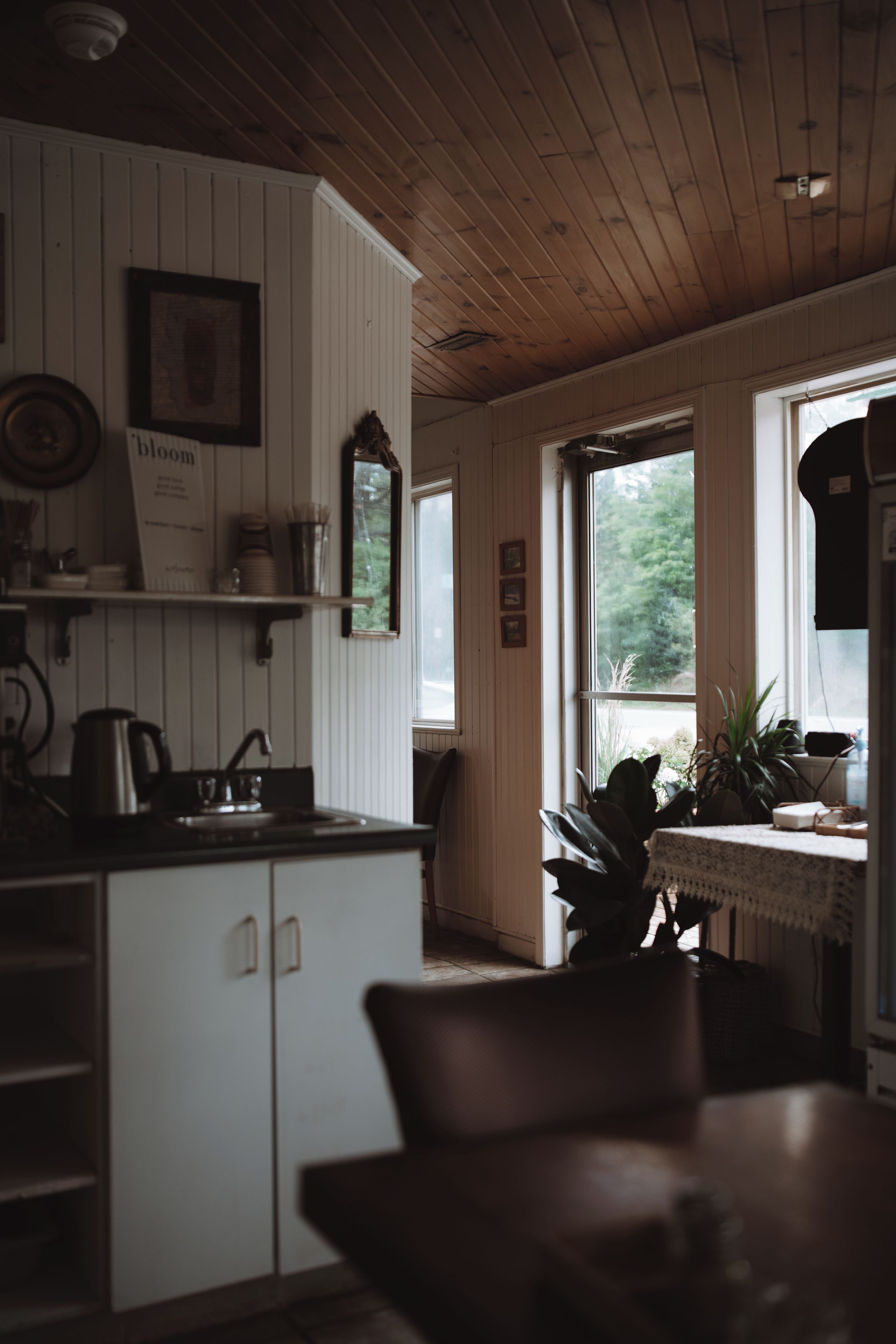 A kitchen with wooden cabinets, a sink, and a window.