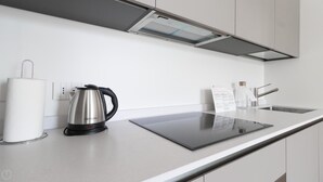 A modern kitchen with a stainless steel kettle, a paper towel holder, and a digital menu board. - Italianway Comfort - Foro Buonaparte 68 (Milan)