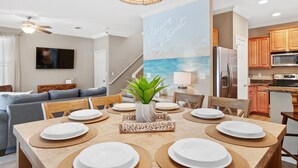 A modern kitchen with wooden cabinets, a stainless steel refrigerator, and a microwave. - KonoVilla * Dog Friendly * Best Lagoon Pool in Destin (Destin)