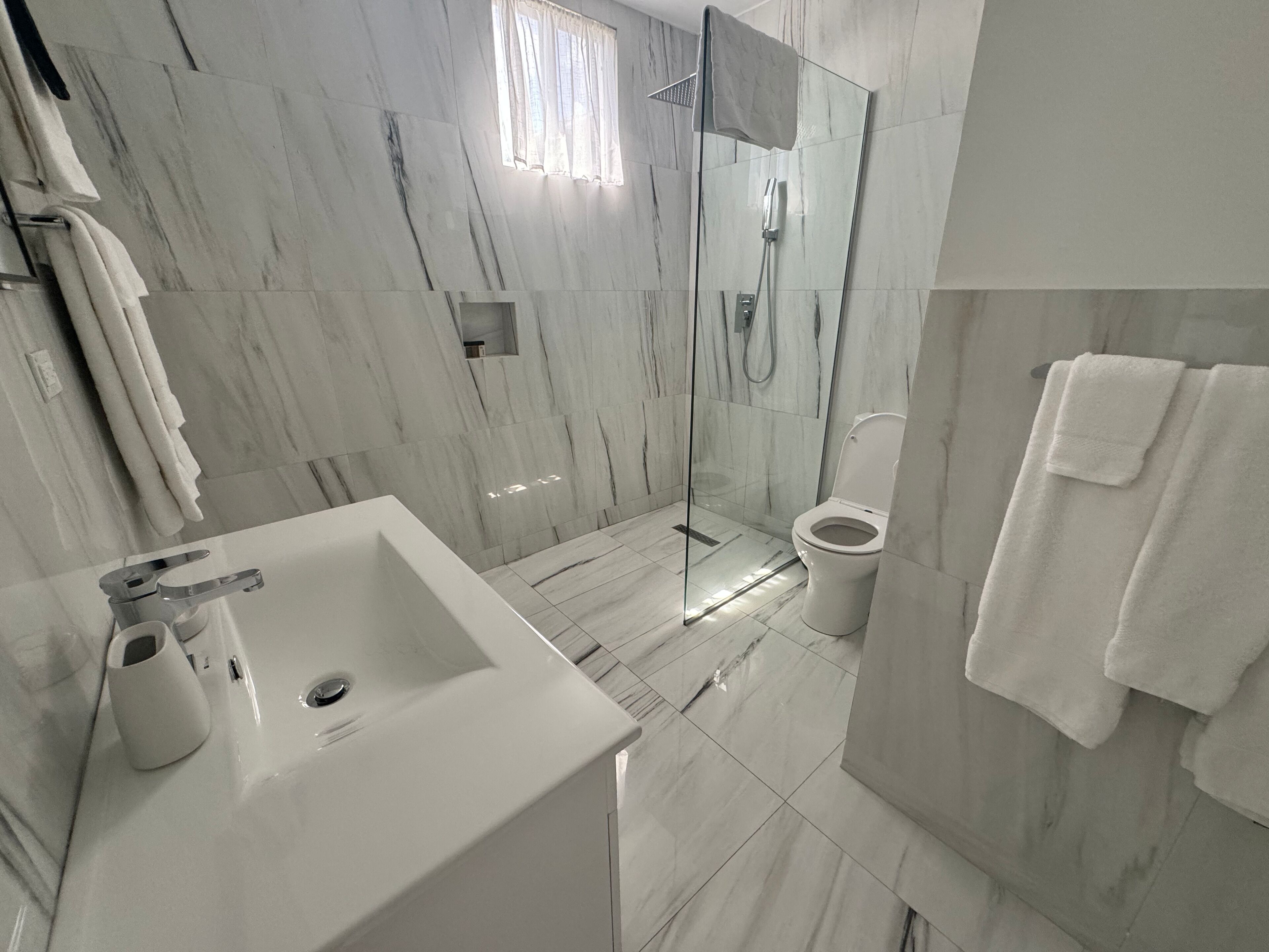 Premium Suite, 2 Bedrooms, Oceanfront | Bathroom | Shower, rainfall showerhead, hair dryer, towels