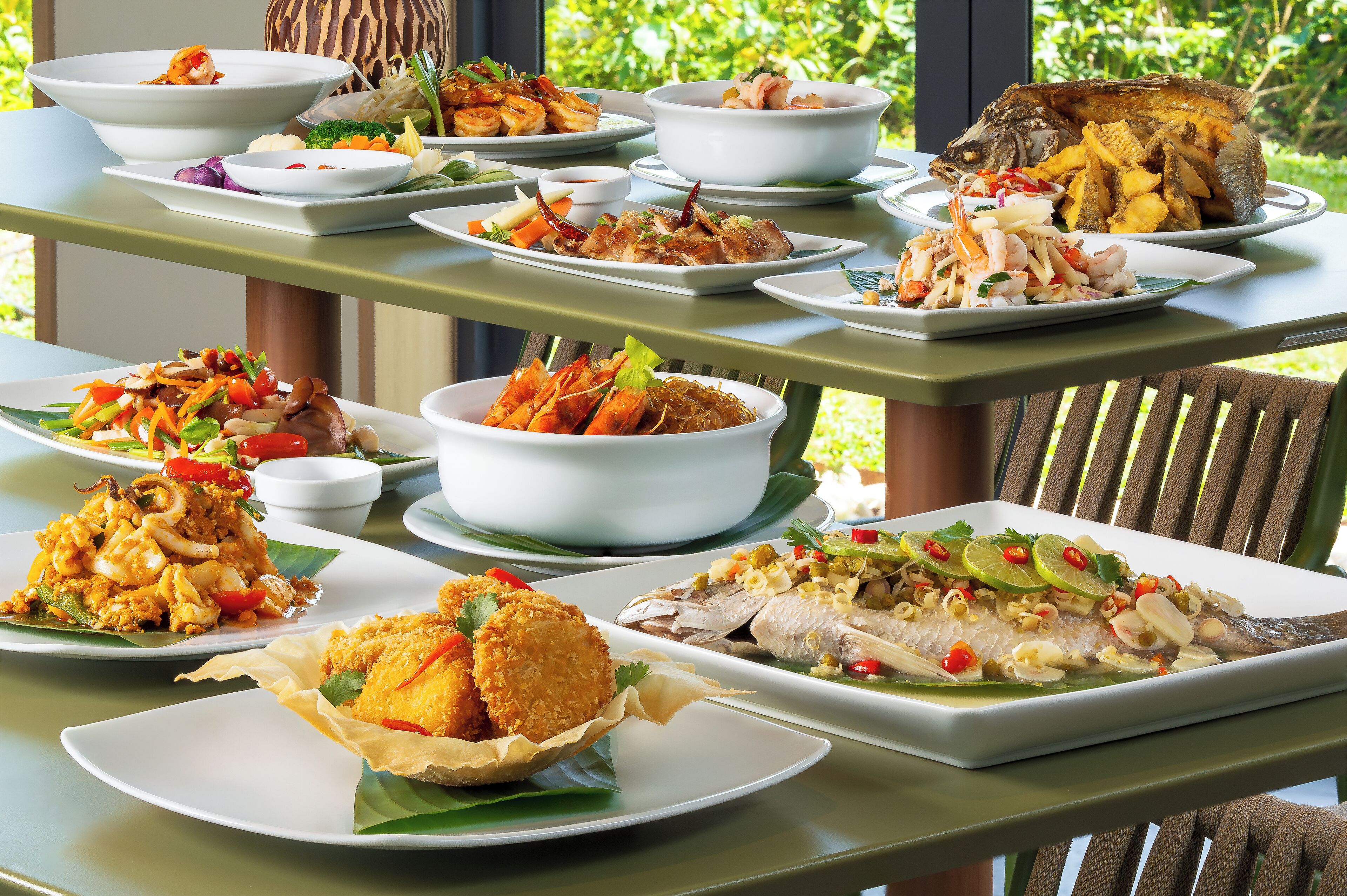 A variety of dishes on a table, including seafood and fried items, suggesting a restaurant setting.