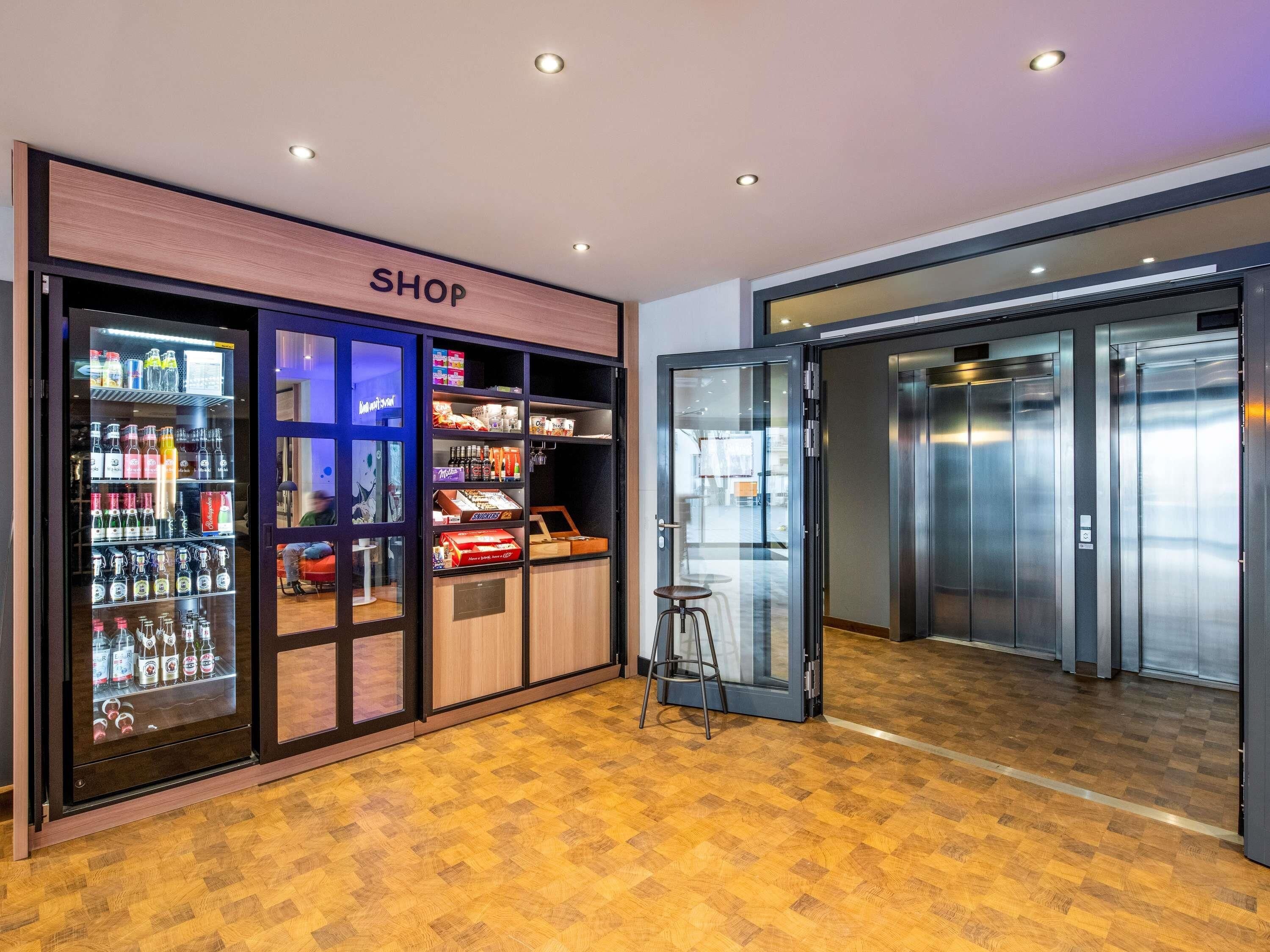 A shop with a variety of products, an elevator, and a wooden floor.