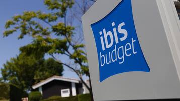 Un letrero con el texto 'ibis budget' en un edificio.