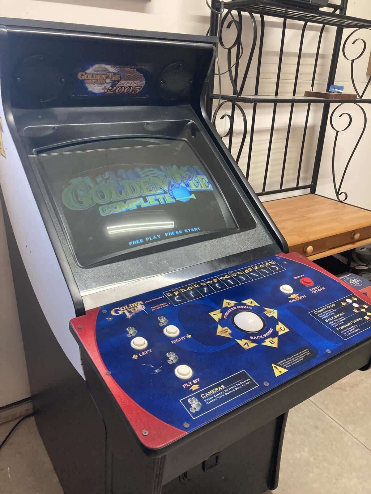 A pinball machine with 'Golden Tee' branding and a 'Fly By' camera feature.