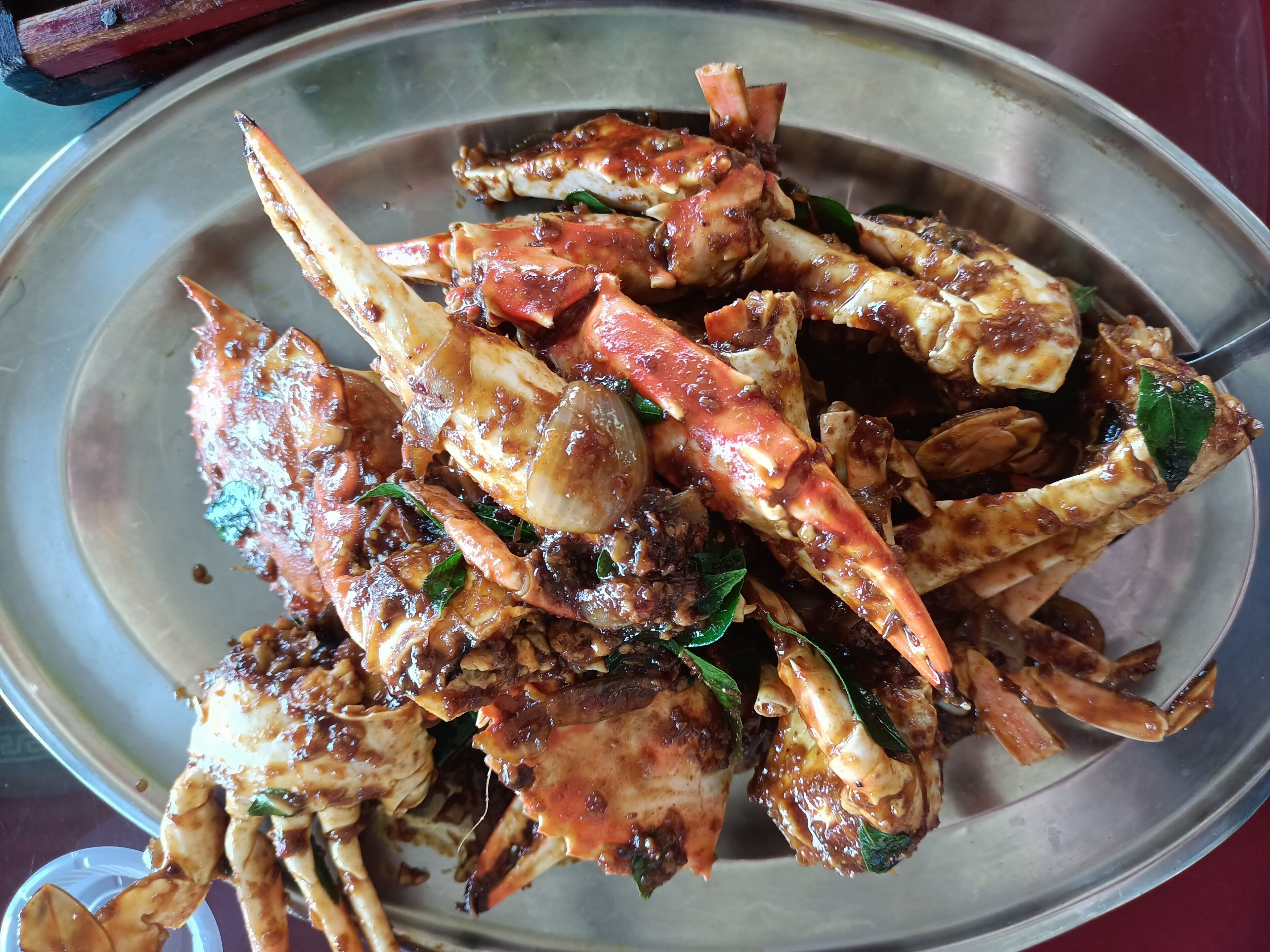 A metal plate with cooked crab legs.