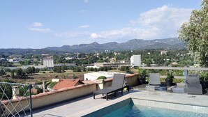A rooftop pool with clear blue water, a view of a cityscape, and a mountainous background. - Happiness and calm to enjoy a magnificent view  (Marseille)