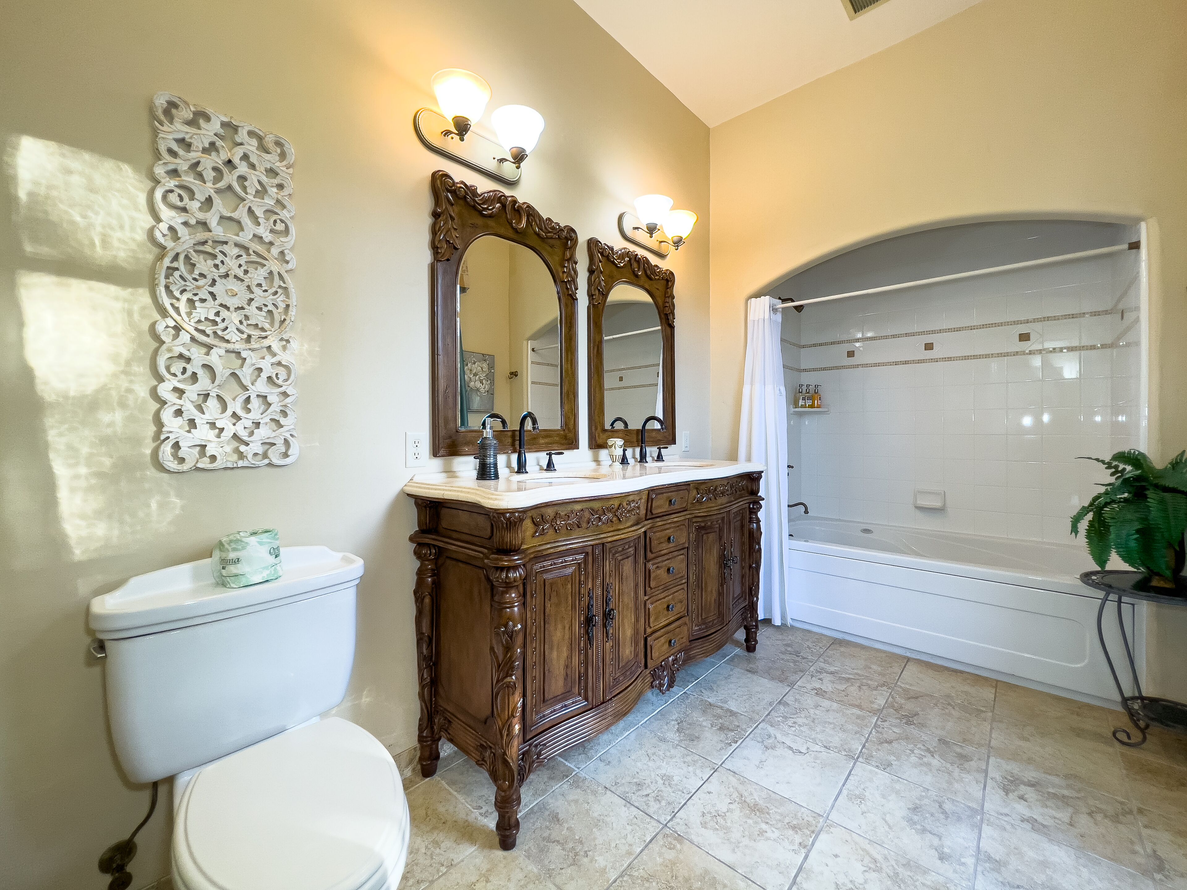 A bathroom with a vanity, a toilet, a bathtub, and a shower.