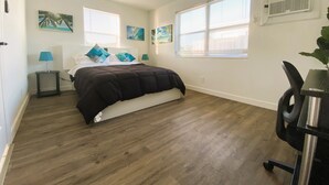 A bedroom with a bed, two nightstands, a ceiling fan, and two windows with blinds. - POMPANO BEACH DELIGHT RETREAT 5' BEACH (Pompano Beach)