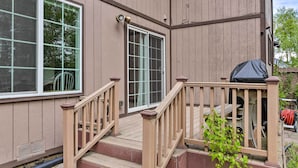 A house with a wooden deck, a sliding glass door, and a covered outdoor area. - 8 Mi to Dtwn Achorage! Home w/ Pet-Friendly Yard (Anchorage)