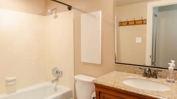 Combined shower/bathtub, towels, soap, shampoo