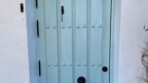 A light blue door with a round handle and a keyhole, set in a white wall with a small step leading up to it. - Family Cottage With Pool and Spectacular Views in a Rural Setting (Velez-Malaga)