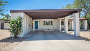 Guests can enjoy a covered patio area and access to the entrance.