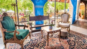 A room with ornate furniture, a patterned rug, and a view of the outdoors. - Mantur Metula by Selina (Metula)