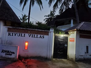 A gated entrance to Kivuli Villas with a sign indicating it is private.