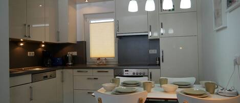 Fridge, stovetop, dishwasher, coffee/tea maker