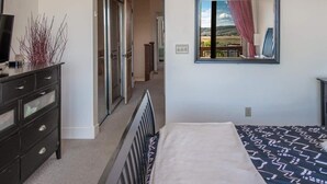 A bedroom with a bed, a dresser, a mirror, and a view of a balcony. - Great Rates, Hot Tub, Tranquil Views & Location (Park City)