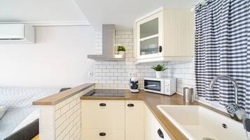 Een koelkast, een magnetron, een kookplaat, een vaatwasser