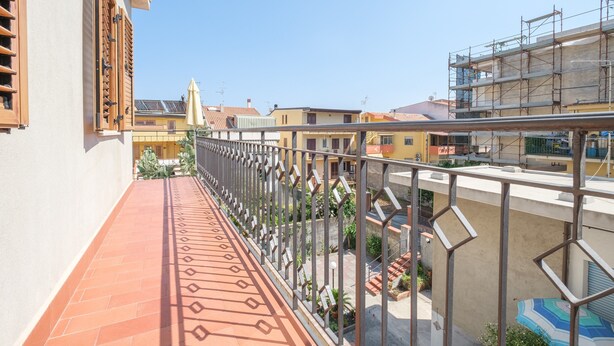 A balcony with a tiled floor, metal railing, and a view of neighboring buildings. - Pet-Friendly 'Holiday Home Santa Teresa Di Riva' with Sea View (santa teresa di riva)