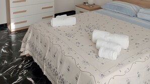 A bedroom with a bed, a dresser, a nightstand, a mirror, and a painting on the wall. - Pet-Friendly 'Holiday Home Santa Teresa Di Riva' with Sea View (santa teresa di riva)