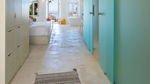 A hallway with a bed, a window, and a bathroom visible in the background. - Samaria by the Sea (Sfakia)