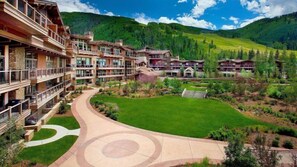 A resort with multiple buildings, a central courtyard, and surrounding greenery.