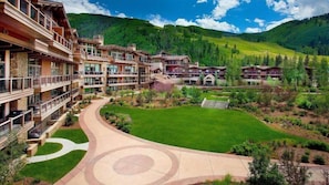 Ein Resort mit mehreren Gebäuden, einem zentralen Innenhof und umliegender Bepflanzung.
