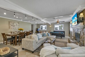 Relax and socialize in this inviting space with a comfortable sofa, dining area, and pool table.