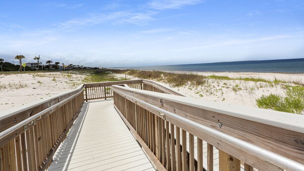 A wooden boardwalk leading to a beach with sand dunes and sparse vegetation. - 175 Steps from the Beach, Sweeping Views, Ground Floor (Mexico Beach)