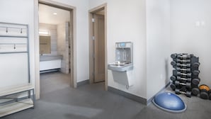 A modern bathroom with a shower, a sink, and a wall-mounted water dispenser. - Lockoff room in heart of Lionshead Village W208B (Vail)