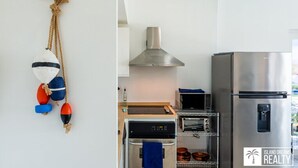 A compact kitchen with a stainless steel refrigerator, a built-in oven, and a microwave. - A Caribbean Dream Vacation w/ Breathtaking Views
 (Sint Maarten)