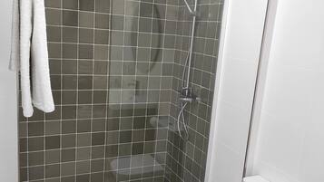 Shower, hair dryer, towels, toilet paper