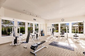 A gym with various exercise equipment, large windows, and a carpeted floor. - Lovers Key Resort Suite 5 - Bay View (Bonita Springs)