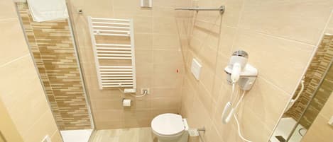A bathroom with a toilet, bidet, and sink.