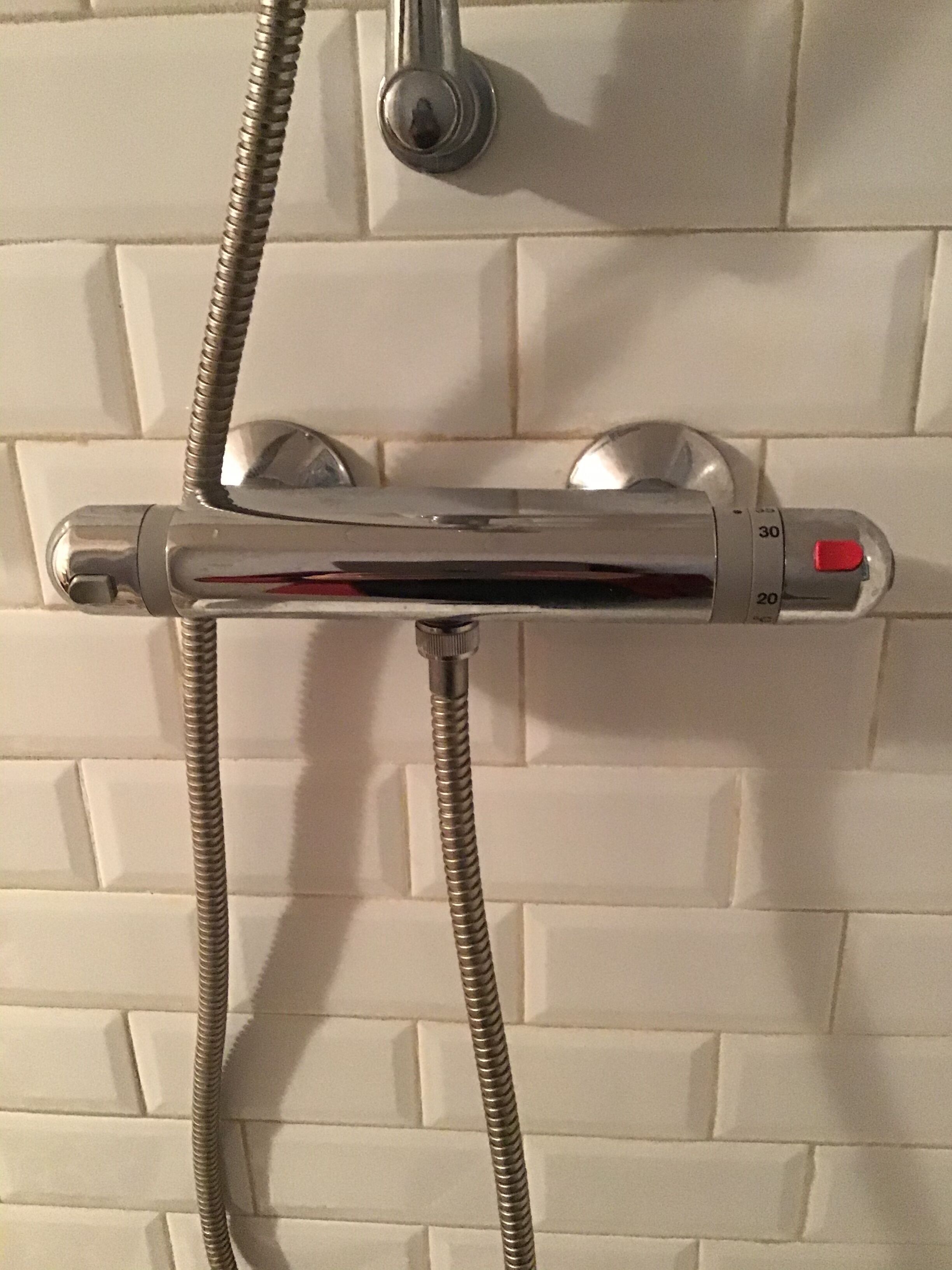 A shower control panel with temperature and water flow settings.