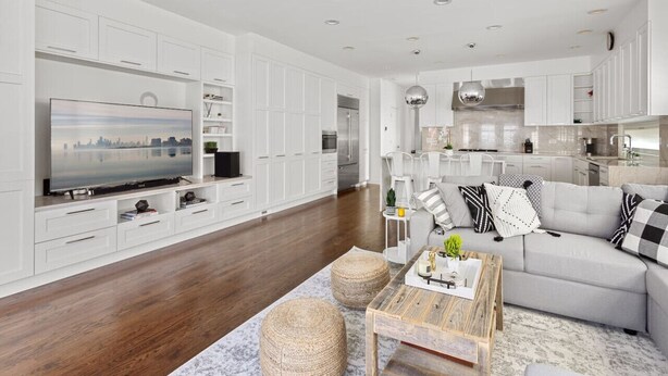A modern living room with a flat-screen TV, a grey sofa, and a wooden coffee table. - Fantastic Home in Wicker Park (Chicago)