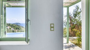 A room with a large window and a door leading outside.