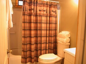 Combined shower/bathtub, hair dryer, towels, soap