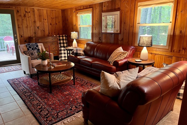Family room with comfortable seating and sliding door to the upper deck.