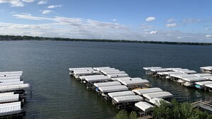 A marina with multiple docked boats and covered structures. - Direct Lakeside View, 5 bed, 2.5 bath Condo at Bridges Bay (Arnolds Park)