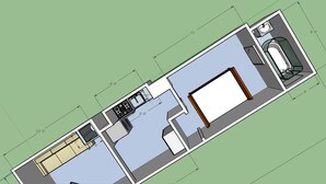 A floor plan of a hotel room with a kitchenette, a bathroom, and a seating area.