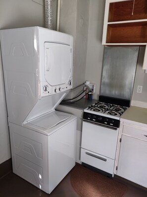 Electric kettle, cookware/dishes/utensils, paper towels, dining tables