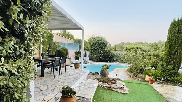 A covered patio area with a pool, stone flooring, and a lawn. - Private villa with pool (Saint-Raphaël)