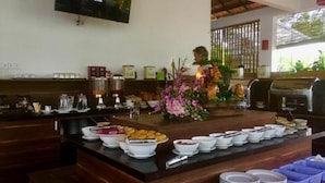 A buffet setup with various food items and dishes.